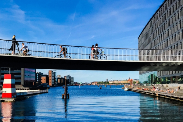 Bikers crossing bridge over river