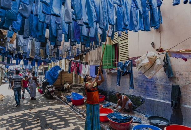 Man drying jeans in the street