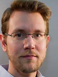 Headshot of Matthew Freedman, smiling with glasses