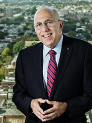 Headshot of Ira Harkavy, smiling with a dark suit