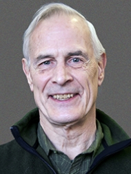 Headshot of Jere Behrman, smiling with a dark shirt