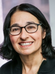 Headshot of Laurie Goodman, smiling with a dark shirt