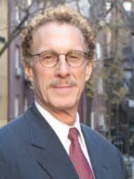 Headshot of Mark Willis, smiling with glasses